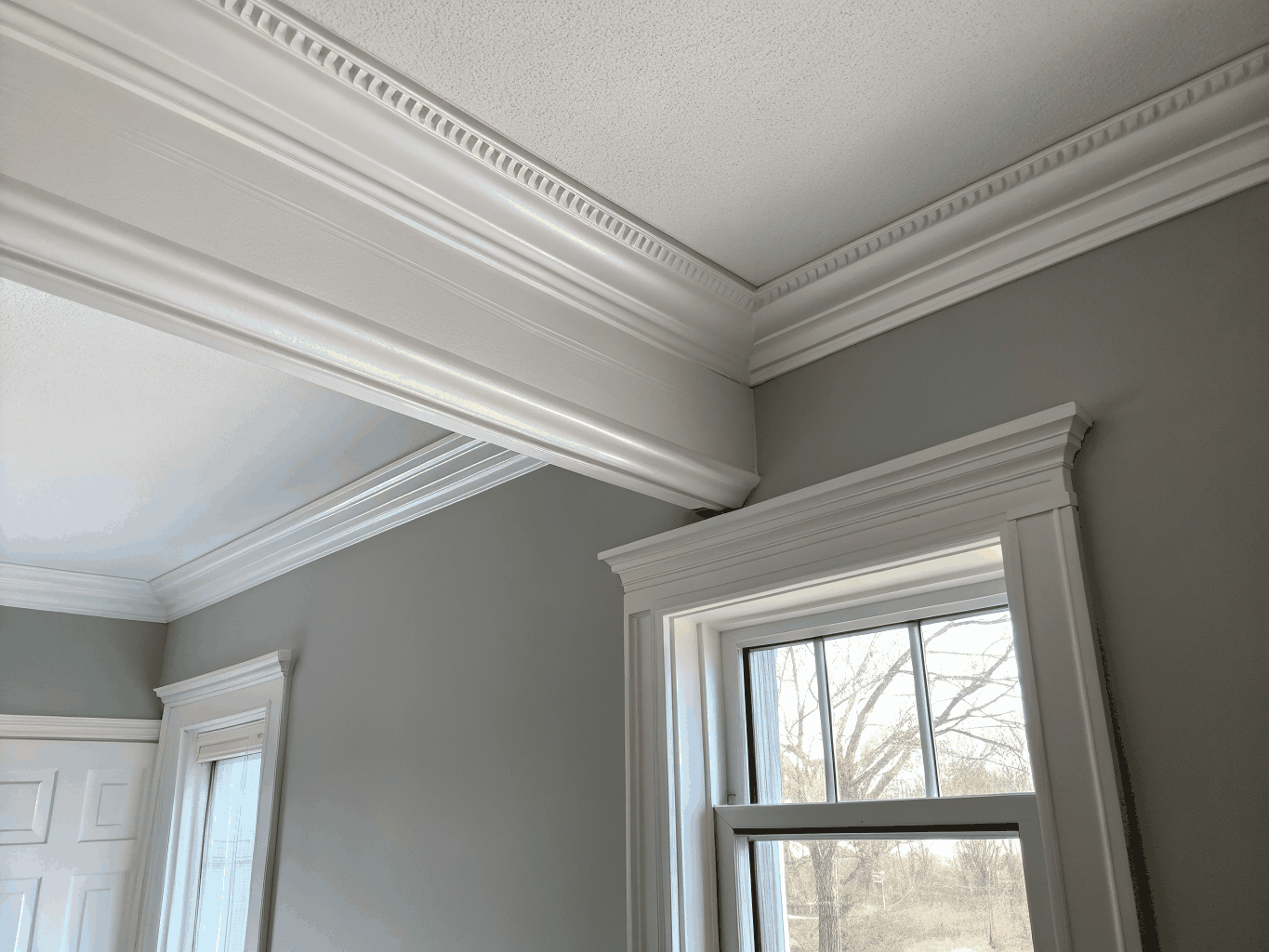Clean mitered door casing and tall baseboard carpentry